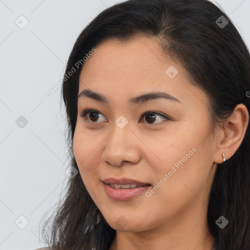 Joyful latino young-adult female with long  brown hair and brown eyes