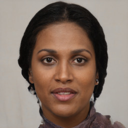 Joyful black young-adult female with medium  brown hair and brown eyes