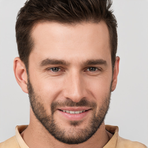 Joyful white young-adult male with short  brown hair and brown eyes