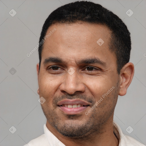 Joyful latino young-adult male with short  black hair and brown eyes