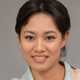 Joyful asian young-adult female with medium  brown hair and brown eyes