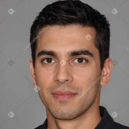 Joyful white young-adult male with short  black hair and brown eyes