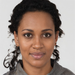 Joyful black young-adult female with medium  brown hair and brown eyes