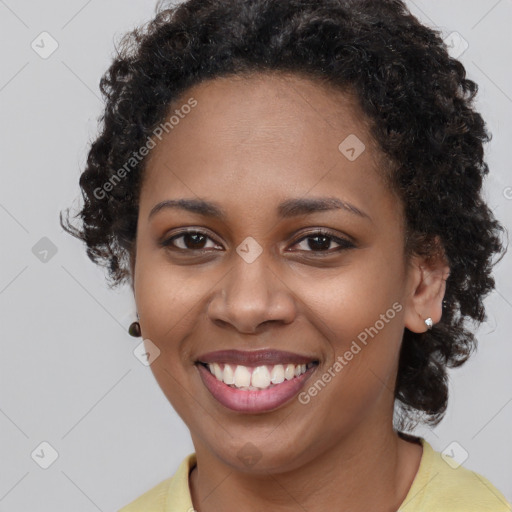 Joyful black young-adult female with short  brown hair and brown eyes