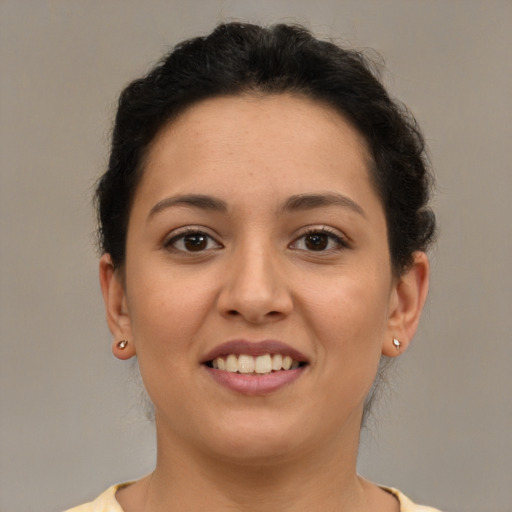 Joyful latino young-adult female with short  brown hair and brown eyes