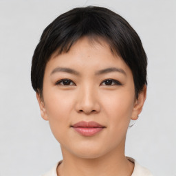 Joyful asian young-adult female with short  black hair and brown eyes