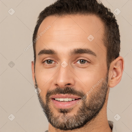 Joyful white young-adult male with short  black hair and brown eyes