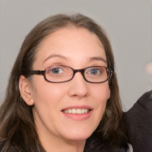 Joyful white adult female with medium  brown hair and grey eyes