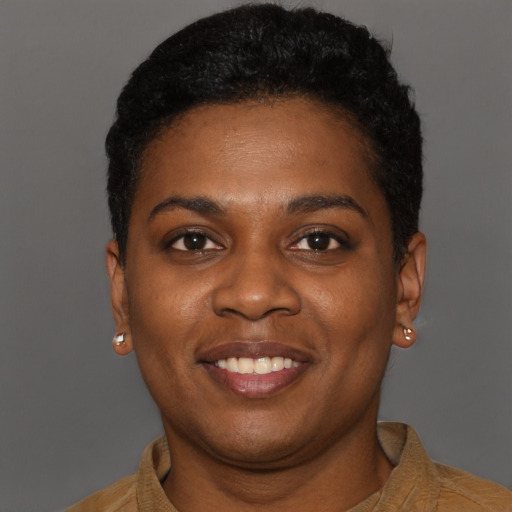 Joyful black young-adult female with short  brown hair and brown eyes
