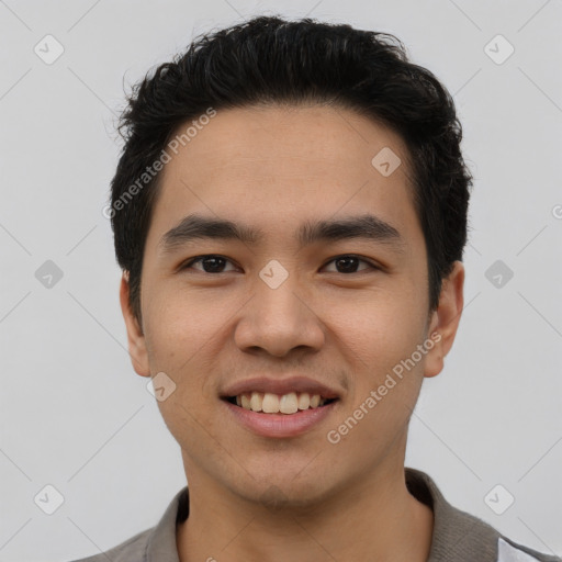 Joyful asian young-adult male with short  black hair and brown eyes