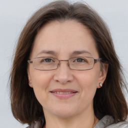 Joyful white adult female with medium  brown hair and grey eyes