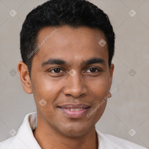 Joyful black young-adult male with short  brown hair and brown eyes