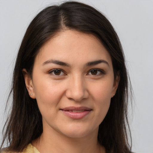 Joyful white young-adult female with long  brown hair and brown eyes