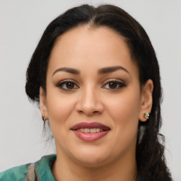 Joyful latino young-adult female with medium  brown hair and brown eyes