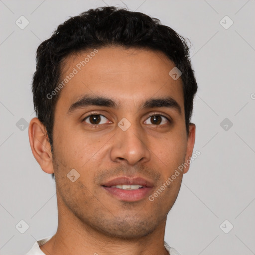 Joyful latino young-adult male with short  black hair and brown eyes