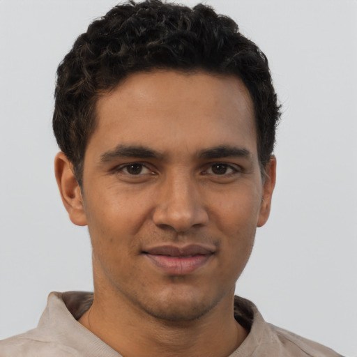 Joyful latino young-adult male with short  brown hair and brown eyes
