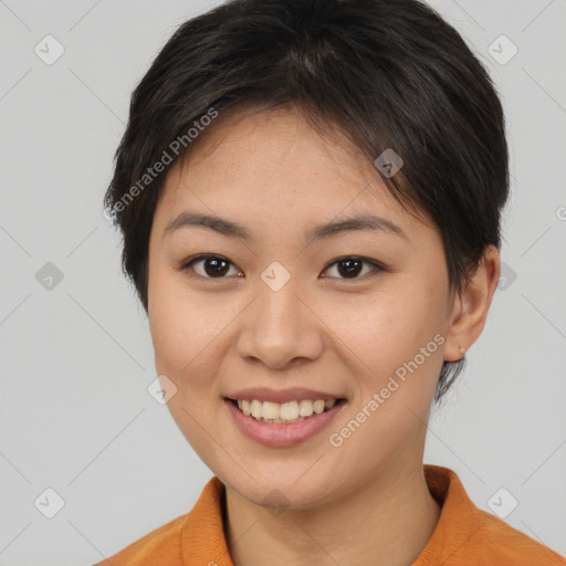 Joyful asian young-adult female with short  brown hair and brown eyes