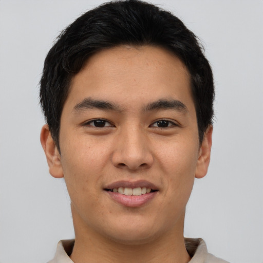 Joyful asian young-adult male with short  brown hair and brown eyes