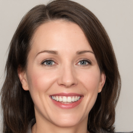 Joyful white young-adult female with medium  brown hair and brown eyes