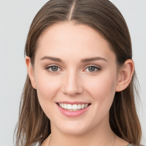 Joyful white young-adult female with long  brown hair and grey eyes