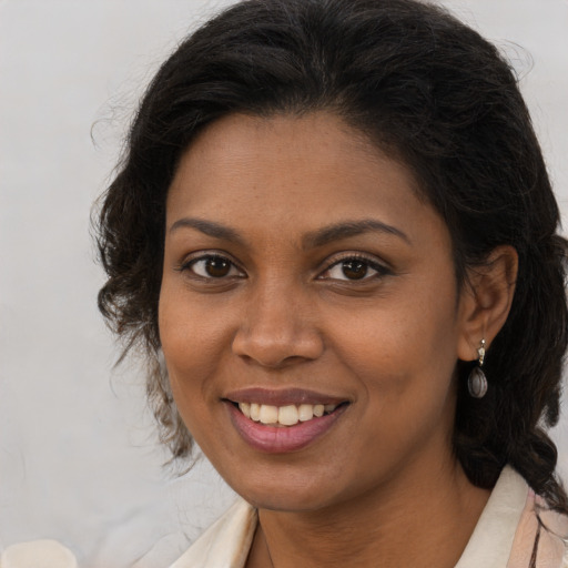 Joyful black young-adult female with medium  brown hair and brown eyes