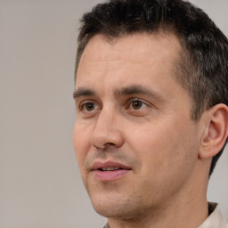 Joyful white adult male with short  brown hair and brown eyes