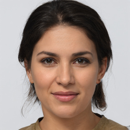 Joyful white young-adult female with medium  brown hair and brown eyes