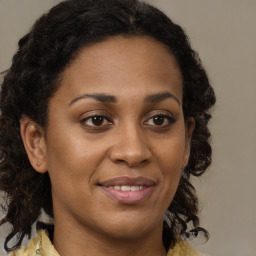 Joyful black young-adult female with medium  brown hair and brown eyes