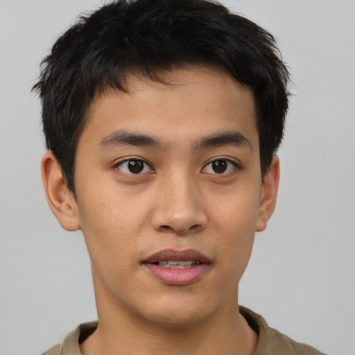 Joyful asian young-adult male with short  black hair and brown eyes