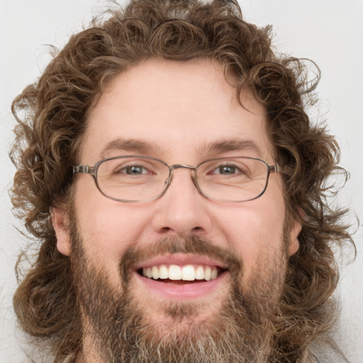 Joyful white adult male with short  brown hair and green eyes