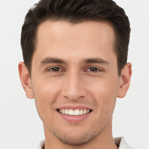 Joyful white young-adult male with short  brown hair and brown eyes