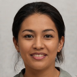 Joyful latino young-adult female with medium  brown hair and brown eyes