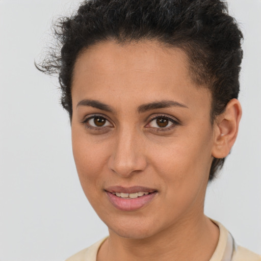 Joyful latino young-adult female with short  brown hair and brown eyes