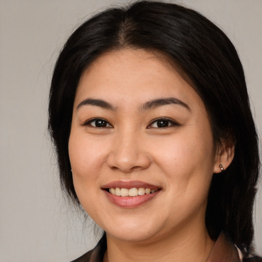 Joyful asian young-adult female with long  brown hair and brown eyes