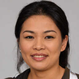 Joyful asian young-adult female with medium  brown hair and brown eyes