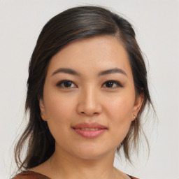 Joyful asian young-adult female with medium  brown hair and brown eyes