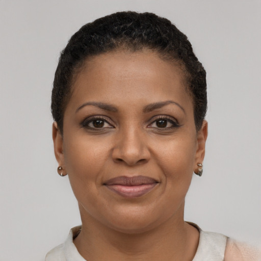 Joyful black young-adult female with short  brown hair and brown eyes