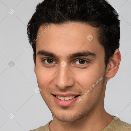 Joyful white young-adult male with short  brown hair and brown eyes