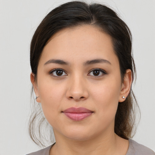 Joyful white young-adult female with medium  brown hair and brown eyes