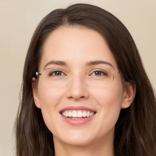 Joyful white young-adult female with long  brown hair and brown eyes