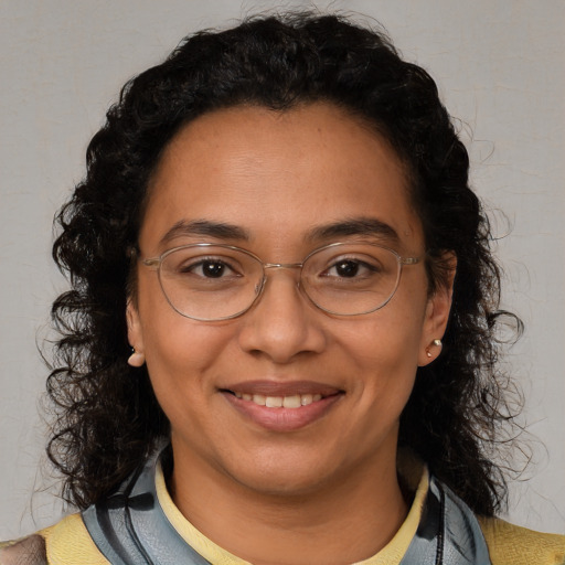 Joyful latino adult female with medium  brown hair and brown eyes