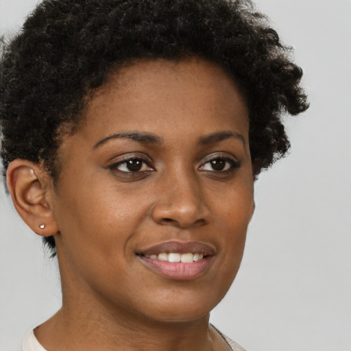 Joyful black young-adult female with short  brown hair and brown eyes