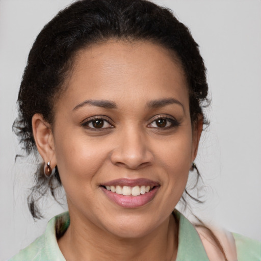 Joyful latino young-adult female with medium  brown hair and brown eyes