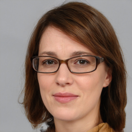 Joyful white young-adult female with medium  brown hair and blue eyes