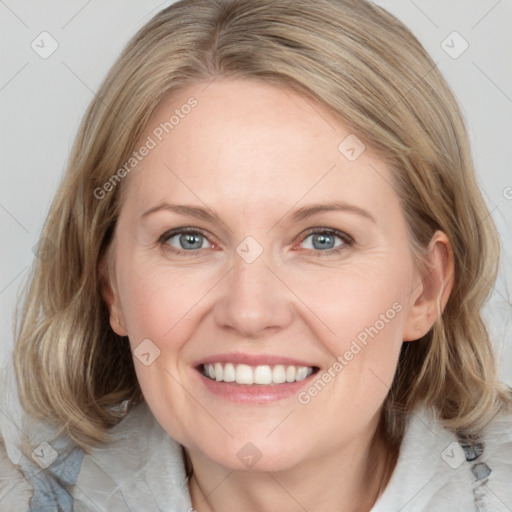 Joyful white adult female with medium  brown hair and blue eyes