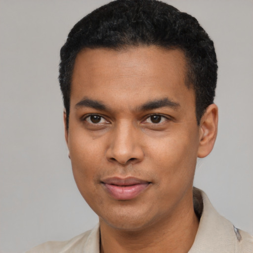 Joyful latino young-adult male with short  black hair and brown eyes
