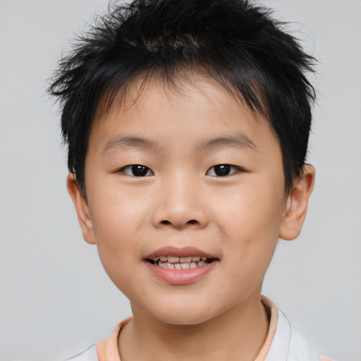 Joyful asian child male with short  brown hair and brown eyes