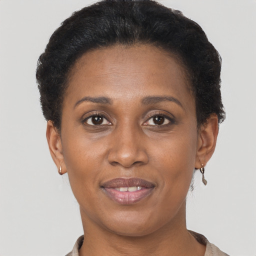 Joyful black adult female with short  brown hair and brown eyes