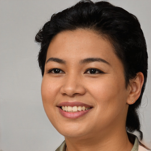 Joyful asian young-adult female with medium  black hair and brown eyes