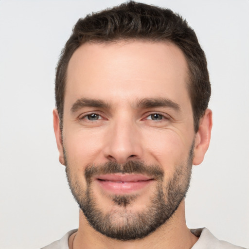 Joyful white young-adult male with short  black hair and brown eyes